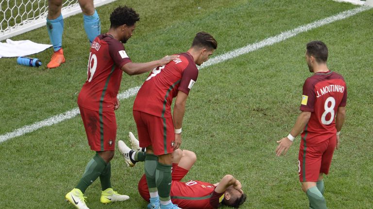 Portugal's midfielder Bernardo Silva (down) reacts with teammates after scoring a goal during the 2017 Confederations Cup group A football match between Ne