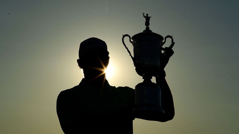 Brooks Koepka of the United States holds the U.S.Open trophy after his four shot win in the final round of the 117th US Open Championship at Erin Hills