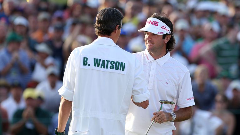 AUGUSTA, GA - APRIL 08:  Bubba Watson of the United States (R) and caddie Ted Scott (L) shake hands during the final round of the 2012 Masters Tournament a