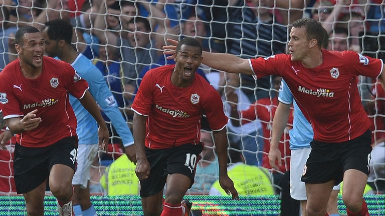 Cardiff City's English striker Fraizer Campbell (2nd L) celebrates with Cardiff City's English defender Steven Caulker (L) and Cardiff City's English defen