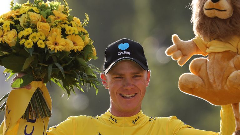 Tour de France 2016's winner Great Britain's Christopher Froome celebrates his overall leader yellow jersey on the podium on the Champs-Elysees avenue in P