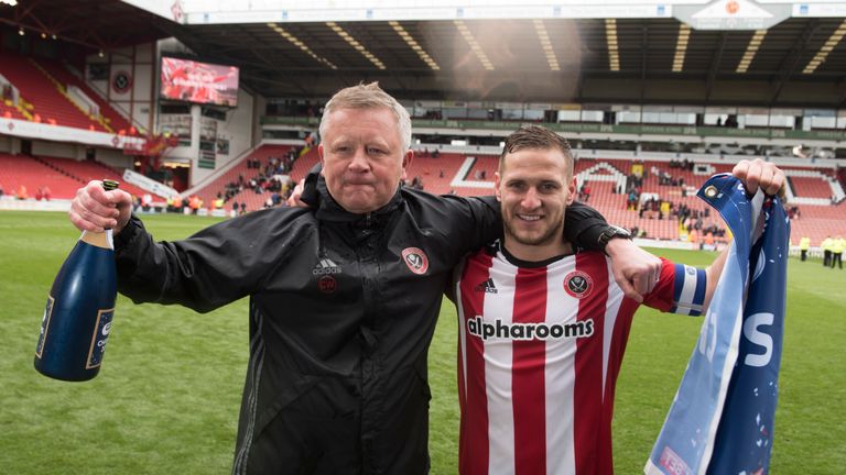 SHEFFIELD, ENGLAND- APRIL 17: Chris Wilder manager of Sheffield United and Billy Sharp celebrate after winning promotion to the Sky Bet Championship after 