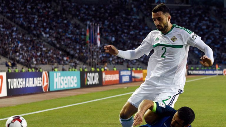 Northern Ireland's defender Conor McLaughlin (TOP) is tackled by Azerbaijan defender Rashad Sadygov during the FIFA World Cup 2018 group C qualifier