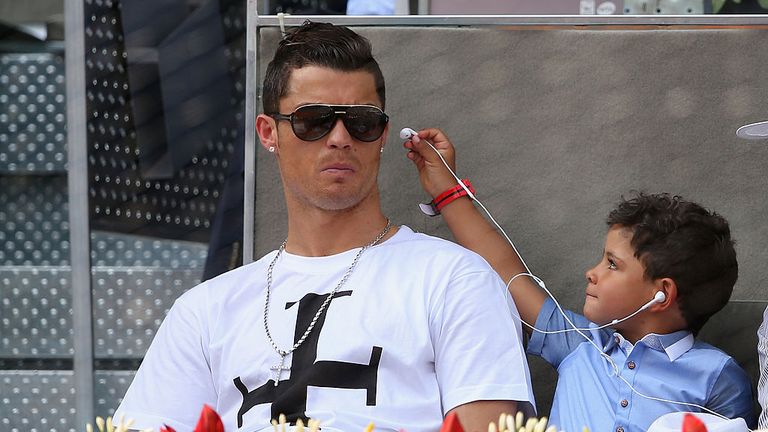 Real Madrid footballer Cristiano Ronaldo and his son Cristiano Ronaldo Junior watch Rafael Nadal of Spain against Jarkko Nieminen