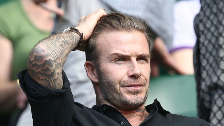 Former England footballer David Beckham watches Switzerland's Roger Federer's victory on centre court after he beat Croatia's Marin Cilic in their men's si