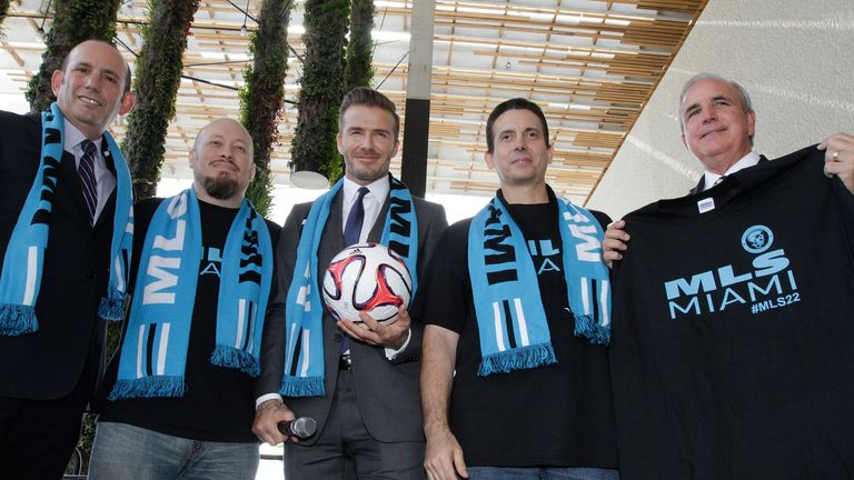 Former  England and Manchester United star, David Beckham(C) poses for photos after holding a press conference at the Perez Art Museum Miami, in Miami, Flo