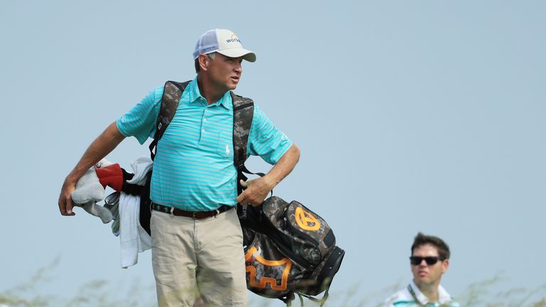 Davis Love III of the United States carries the bag of his son Davis Love IV during a practice round prior to the 2017 U.S. Open