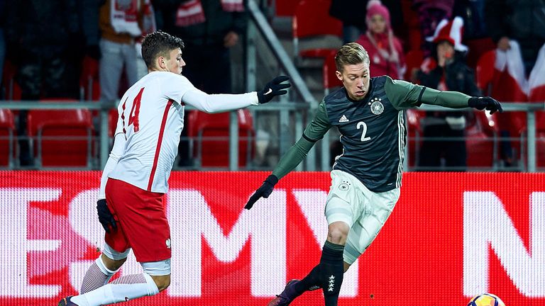 TYCHY, POLAND - NOVEMBER 15: Mitchell Weiser from Germany (R) fights for the ball with Dawid Kownacki from Poland (L) during the International Friendly soc