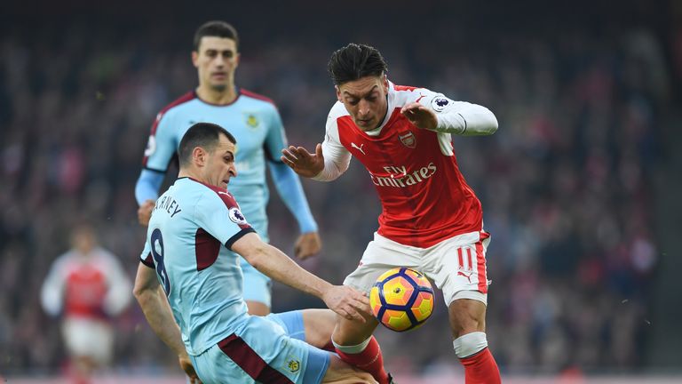 LONDON, ENGLAND - JANUARY 22:  Mesut Ozil of Arsenal is challenged by Dean Marney of Burnley during the Premier League match between Arsenal and Burnley at
