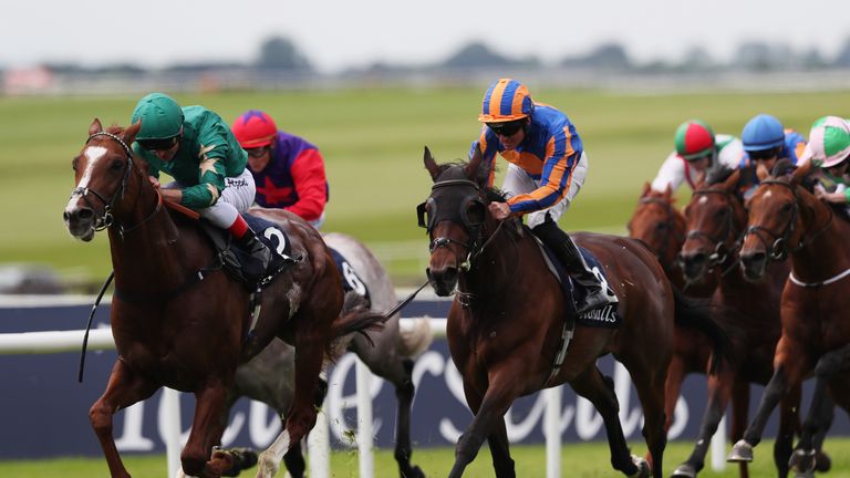 Decorated Knight ridden by Andrea Atzeni (left) on the way to winning the Tattersalls Gold Cup at the Curragh Racecourse, Co. Kildare.