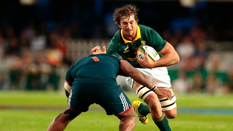 TOPSHOT - Eben Etzebeth of South Africa (R) is tackled by Jefferson Poirot of France (L) during the International test match between South Africa and Franc