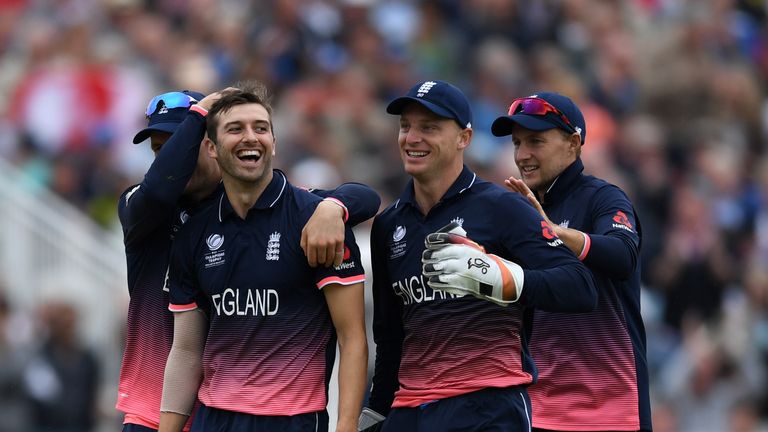 Mark Wood of England celebrates with teammates after dismissing Australian captain Steve Smith during the ICC Champions Tro