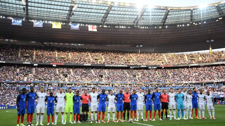 England and French players stand together ahead of the international friendly football match between France and England at The Stade de France Stadium in S