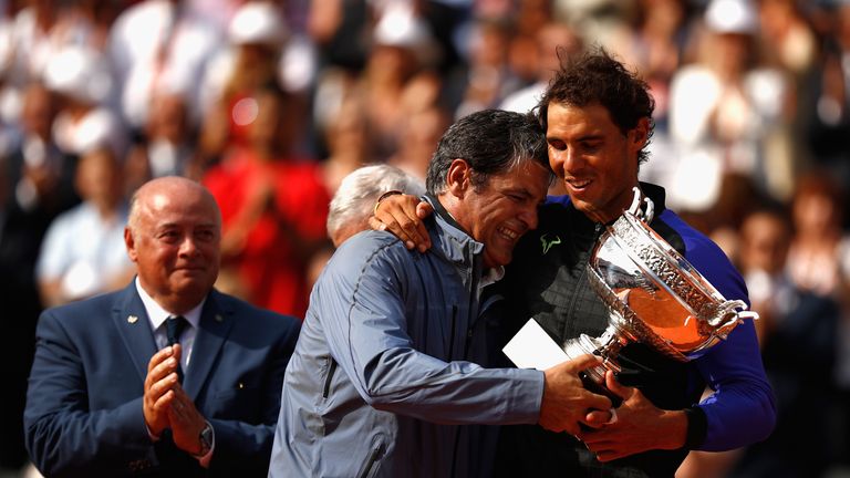 Rafael Nadal of Spain and his coach, Toni Nadal celebrate with the trophy following the mens singles final against Stan Wawrinka