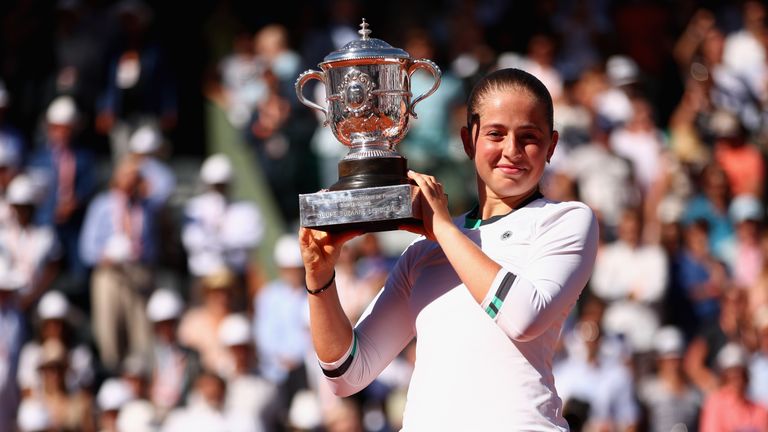 Jelena Ostapenko of Latvia celebrates victory with the trophy following the ladies singles final match against Simona Halep