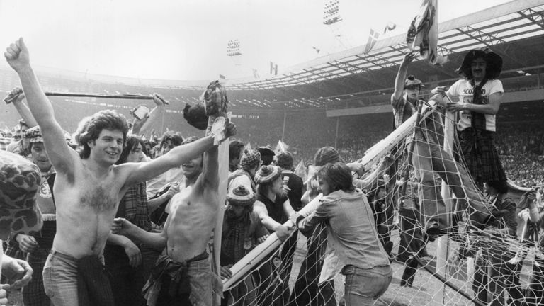 Scottish football fans, known as the Tartan Army, invading the pitch and pulling down goalposts after Scotland beat England 2-1 at Wembley Stadium