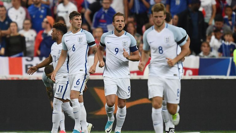 Harry Kane (C) celebrates with team-mates after scoring a penalty during the international friendly football match between France and England