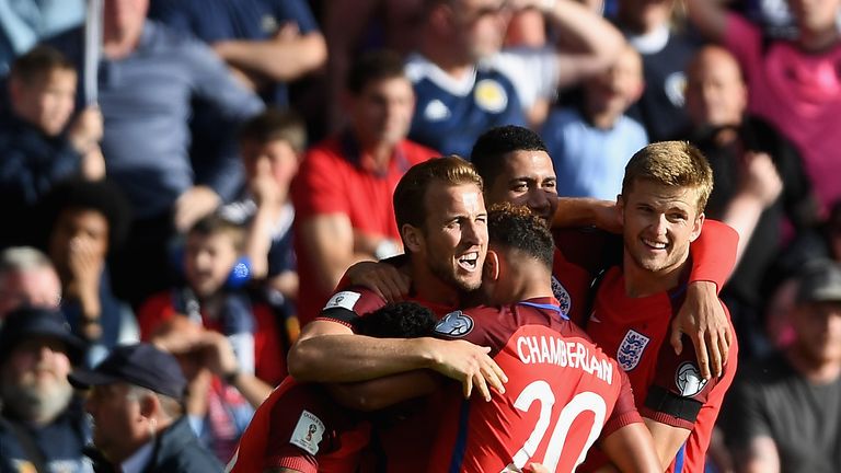 Harry Kane of England celebrates scoring his side's second goal with his team-mates during the FIFA 2018 World Cup Qualifier v Scotland at Hampden