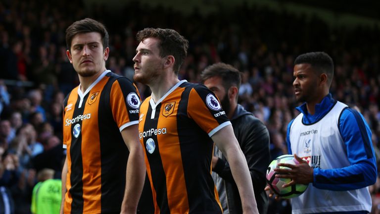 LONDON, ENGLAND - MAY 14: Harry Maguire of Hull City and Andrew Robertson of Hull City leave the pitch looking dejected after being relegated to the Champi