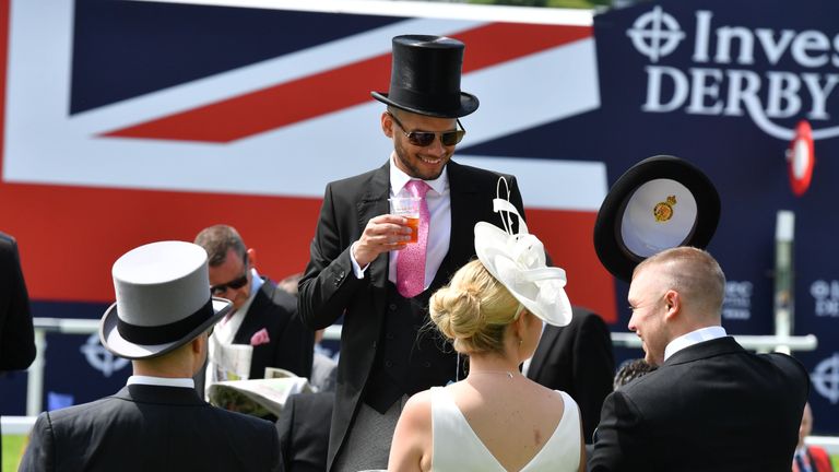 Racegoers sip champagne ahead of the Investec Derby 