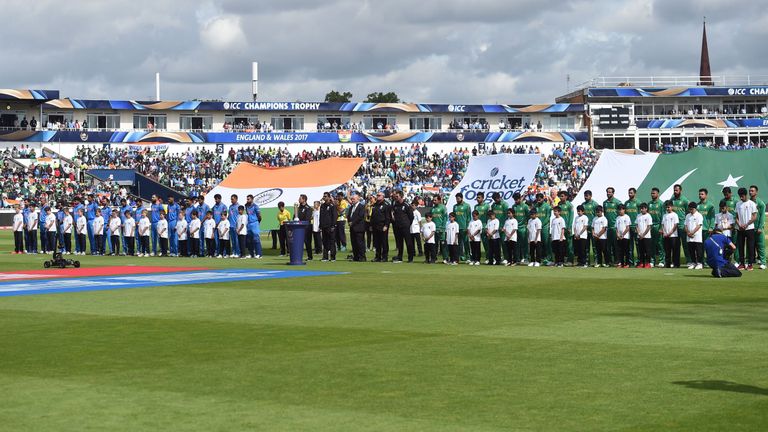 India (L) and Pakistan players hold a minutes' silence for the London terror attack victims ahead of the ICC Champions trophy cricket match between India a