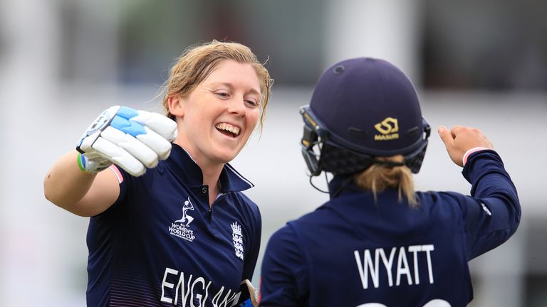 Heather Knight (left) leaves the field after being dismissed and embraces team-mate Danielle Wyatt