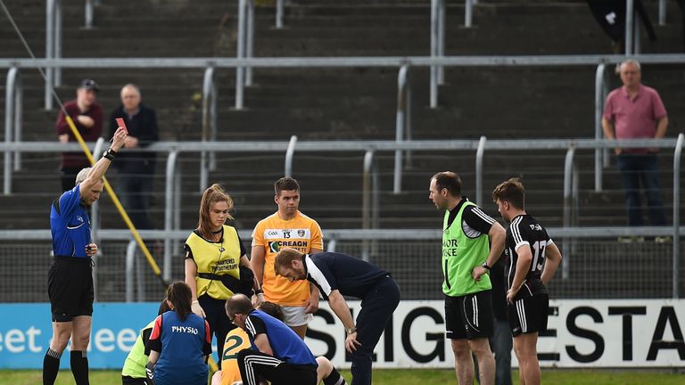 Referee Fergal Kelly shows a red card to Jack Dowling of Antrim, hidden, during the GAA Football All-Ireland Senior Championship Round 1A