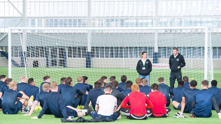 Jamie Vardy, alongside wife Rebekah, addresses players at the V9 Academy