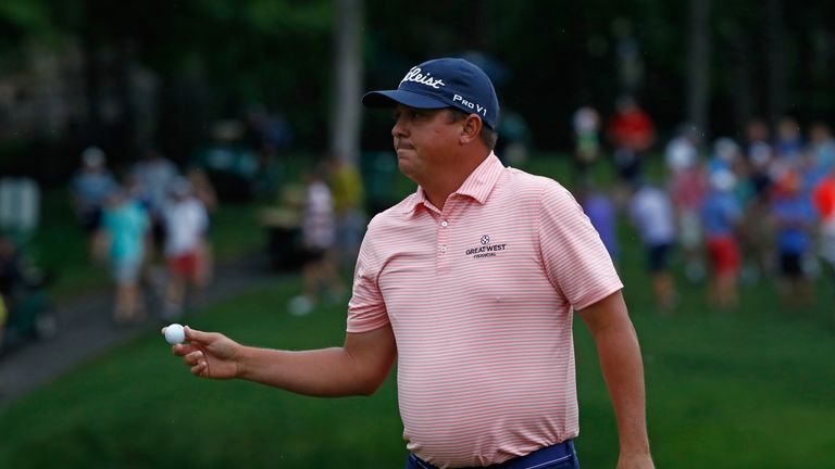 Jason Dufner waves to the gallery after making a birdie on the 15th hole during the final round of the Memorial Tournament
