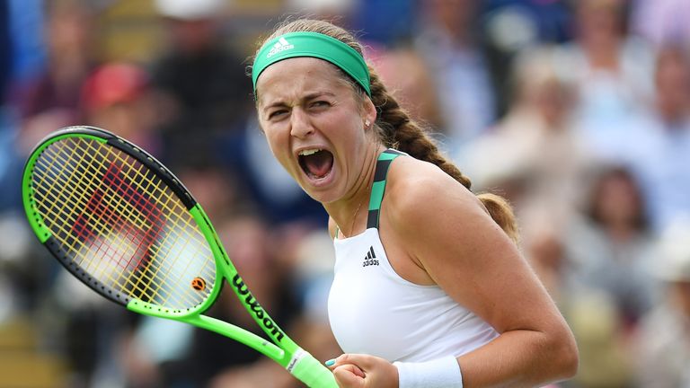 Jelena Ostapenko of Latvia celebrates winning the second set against Johanna Konta