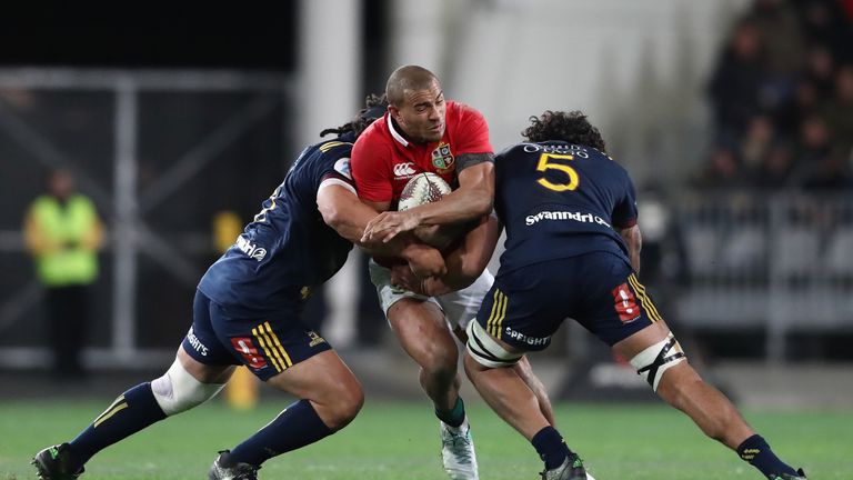 DUNEDIN, NEW ZEALAND - JUNE 13:  Jonathan Joseph of the Lions is tackled by Aki Seiuli (L) and Jack Hemopo (R) of the Highlanders during the 2017 British &