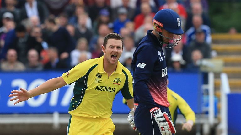 Australia's Josh Hazlewood (L) celebrates taking the wicket of England's Alex Hales (R) during the ICC Champions Trophy match between England and Australia