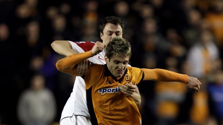 Kevin Doyle (L) of Wolves is grabbed by Jonny Evans of Manchester United in 2011