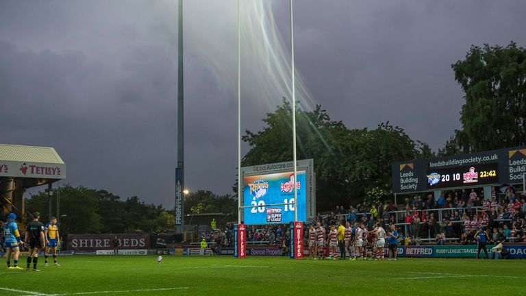 Leeds's Liam Sutcliffe lines up a conversion as rain swirls down.