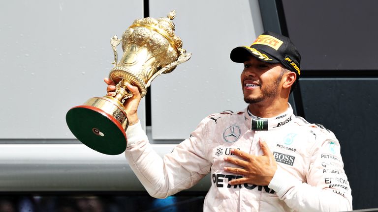 NORTHAMPTON, ENGLAND - JULY 10:  Lewis Hamilton of Great Britain and Mercedes GP celebrates his win on the podium during the Formula One Grand Prix of Grea