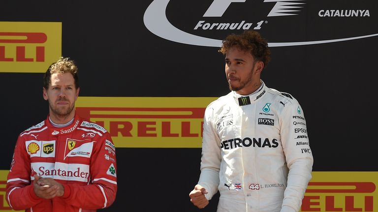 (L to R) Ferrari's German driver Sebastian Vettel, Mercedes' British driver Lewis Hamilton celebrate on the podium after the Spanish Formula One Grand Prix