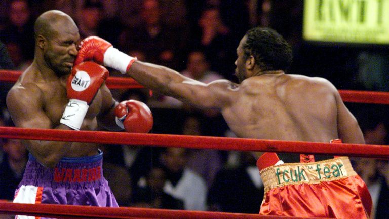 NEW YORK, UNITED STATES:  IBF and WBA Heavyweight Champion Evander Holyfield (L) gets hit in the face with a punch by WBC heavyweight Champion Lennox Lewis