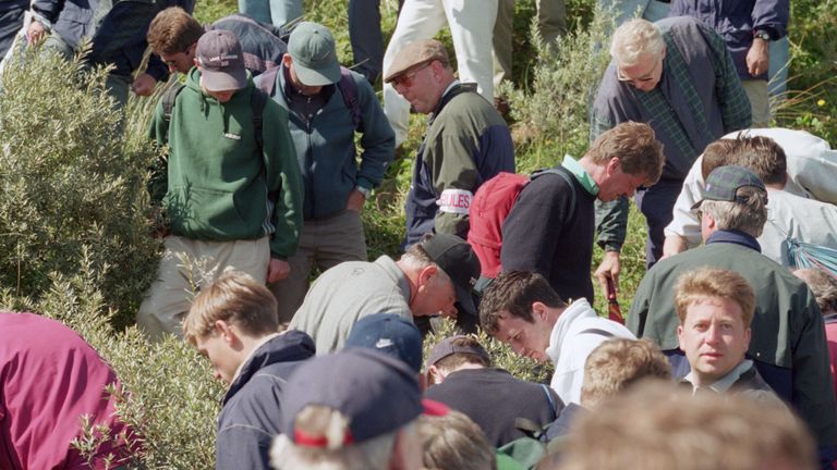 Spectators help American golfer Mark O'Meara (centre) to look for a lost ball at the British Open at the Royal Birkdale Golf Club, Southport, 18th July 199