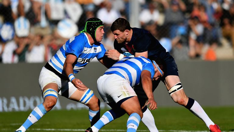 Mark Wilson of England is tackled by  Matias Alemanno  and Lucas Noguera of Argentina 