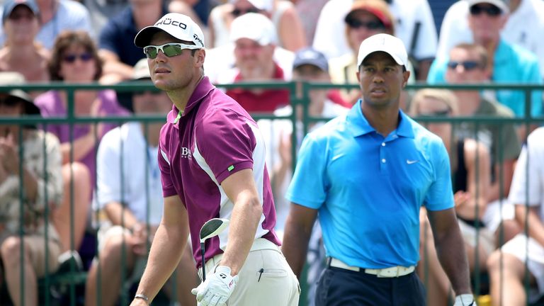 KIAWAH ISLAND, SC - AUGUST 10: Martin Kaymer of Germany (L) watches his shot off the first tee as Tiger Woods of the United States looks on during Round Tw