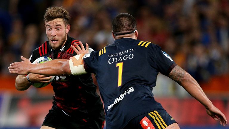 DUNEDIN, NEW ZEALAND - MARCH 04:  Mitchell Hunt (L) of the Crusaders fends off Daniel Lienert-Brown of the Highlanders during the round two Super Rugby mat