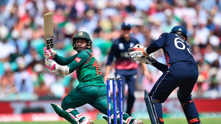 Bangladesh's Mushfiqur Rahim (L) watches his chipped shot go toward the boundary behind the stumps during the ICC Champions trophy cricket match between En
