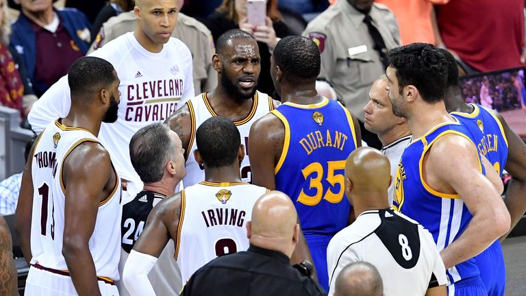 LeBron James #23 of the Cleveland Cavaliers and Kevin Durant #35 of the Golden State Warriors speak after a foul in the third quarter