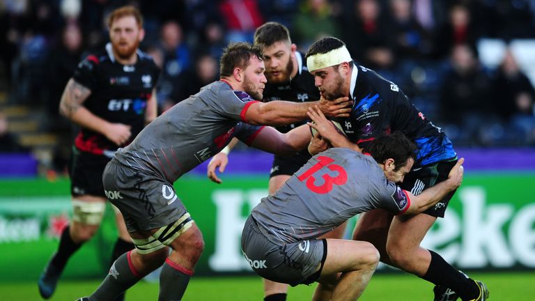 SWANSEA, UNITED KINGDOM - JANUARY 15: Nicky Smith of Ospreys is tackled by Paul Bonnefond of Lyon during the European Rugby Challenge Cup match between Osp