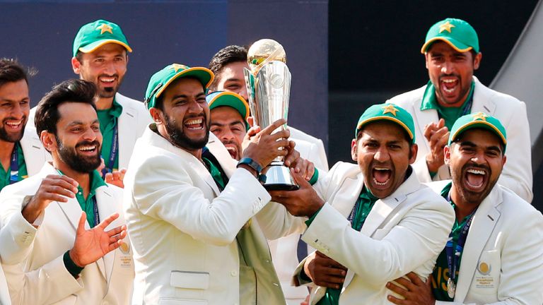 Pakistan's Sarfraz Ahmed (3R) lifts the trophy as Pakistan players celebrate their win at the presentation after the ICC Champions Trophy final cricket mat