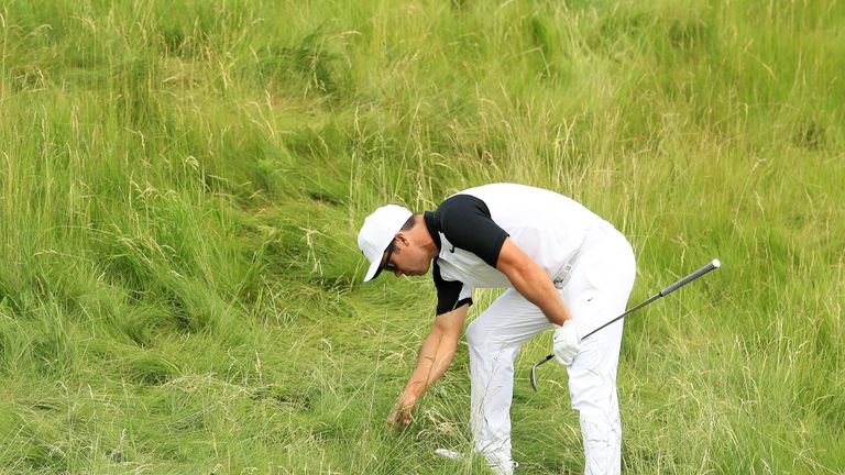 Paul Casey of England searches for his ball on the 14th hole during the second round of the 2017 U.S. Open at Erin Hills