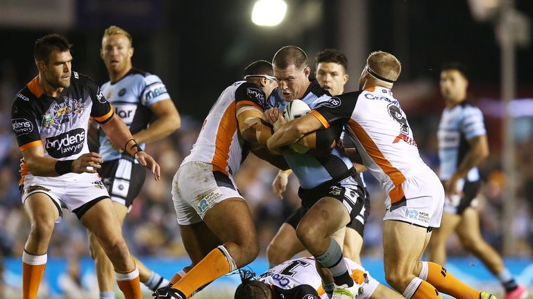 SYDNEY, AUSTRALIA - JUNE 17:  Paul Gallen of the Sharks is tackled during the round 15 NRL match between the Cronulla Sharks and the Wests Tigers at Southe