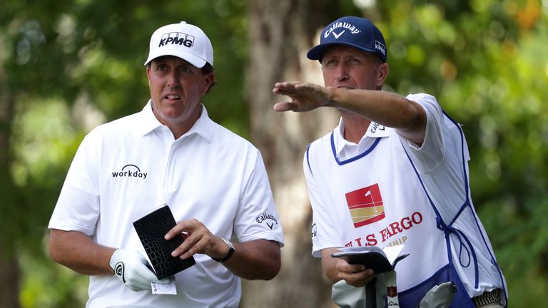WILMINGTON, NC - MAY 4: Phil Mickelson lines up a drive with his caddie Jim Mackay on the 11th tee during round one of the Wells Fargo Championship