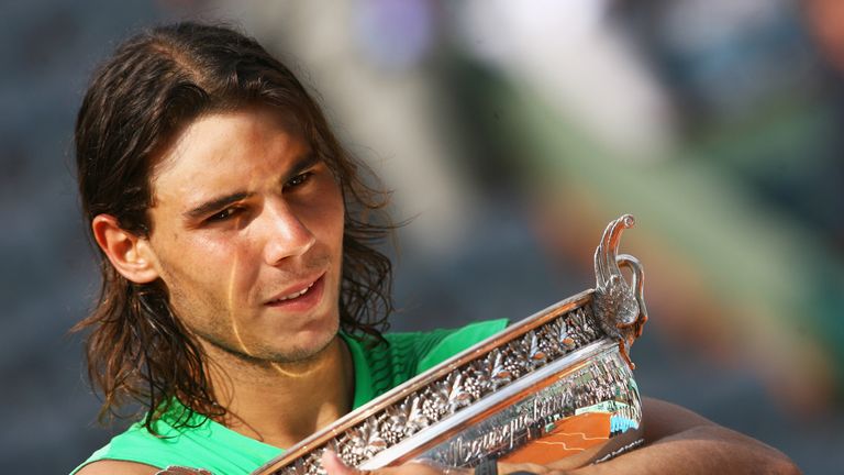 Rafael Nadal of Spain hugs the trophy following his victory during the Men's Singles Final match against Roger Federer of Switzerland