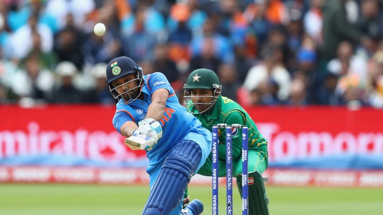 BIRMINGHAM, ENGLAND - JUNE 04:  Rohit Sharma of India hits straight as Pakistan wicketkeeper Sarfraz Ahmed looks on during the ICC Champions Trophy match b